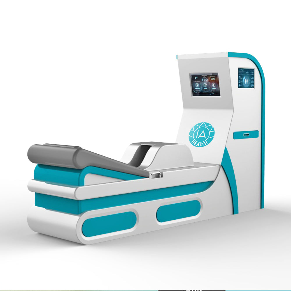 Sleek 3D render of the IA colonic hydrotherapy device in teal and white, showing the angled treatment bed, touchscreen interface, and minimalist open-system design.